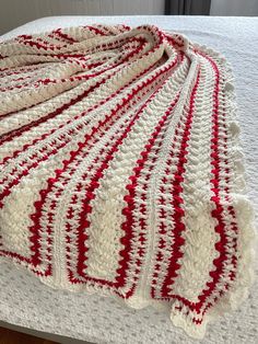 a crocheted blanket sitting on top of a bed