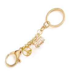 a gold key chain with scissors and charms