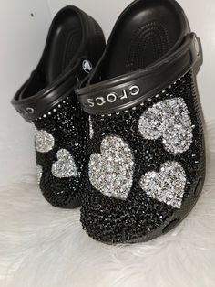 Women's size (black) clogs bling out with black diamonds with silver hearts You can request a different color clog by request. Can be substituted with gold hearts by request. Can be done with stars by request Bedazzled Crocs Winter's Lemonade Stand, Bedazzled Crocs Shoes Pink, Decorated Crocs, Customize Crocs, Croc Ideas, Bedazzled Shoes Diy, Bling Crocs, Bedazzled Shoes, Custom Sneakers Diy