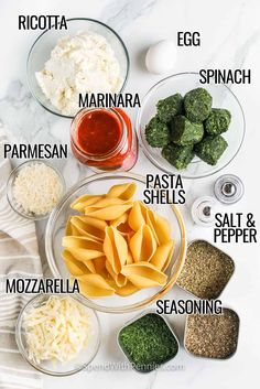 the ingredients to make pasta in bowls on a table