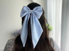 "Premium quality blue chiffon medium hair bow with pointed tail. Perfect accessory and gift for girls! This stylish hair bow is an ideal hair accessory for wearing to a special occasion or even everyday wear. 🎁It will also make a great \"gift for girl.\" They are handmade with love and care from  high quality fabric in our studio in England. 📍Attachment:  ✅Barrette  ✅Comb Slide ✅Alligator Clip 📏Bow measurement  15cm or 6\" in width appx  9 cm or 3 1/2\" in height  Tail is 21.50 cm or 8 1/2\" long (measured excluding the bow) *Please be noted that the color might appear a little differently on each phone, tablet, or computer screen." Hair Tie Accessories, Bow Hairstyle, Ribbon Hairstyle, Christmas Gifts For Girls, Ribbon Hair, Diy Hair Bows, Diy Hair Accessories, Blue Bow, Stylish Hair