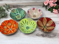 four decorative bowls are sitting on a table