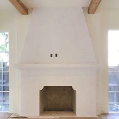 an empty room with a fire place in the middle