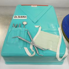 a cake that is shaped like a surgeon's bag with scissors and instruments on it