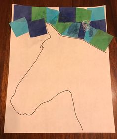 the paper is cut out to look like a horse's head with blue and green squares on it