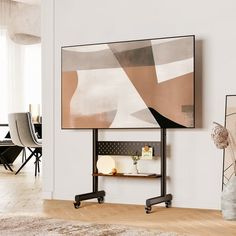 a living room with a large painting on the wall next to a table and chairs