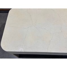 a white marble table with black metal legs