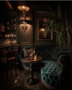 a dark room with two couches and a table in front of the bar area