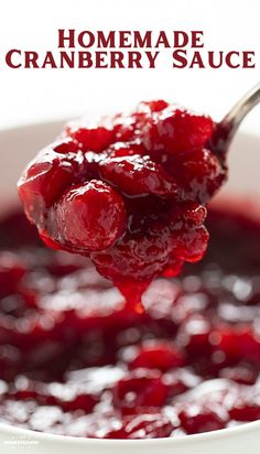 a spoon full of cranberry sauce with the words homemade cranberry sauce on it