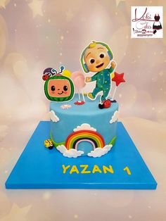 a birthday cake with an image of two children on top and a rainbow in the middle