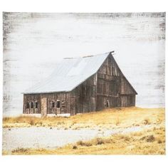 an old barn sitting in the middle of a dry grass field on a cloudy day