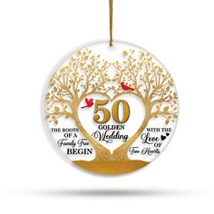 50th wedding ornament with tree and birds on it, in gold foiled paper