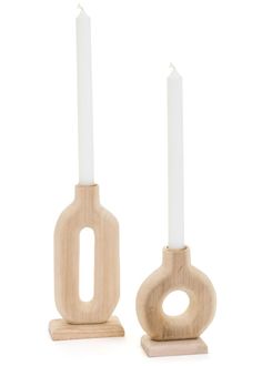 two wooden candlesticks sitting next to each other on top of a white surface