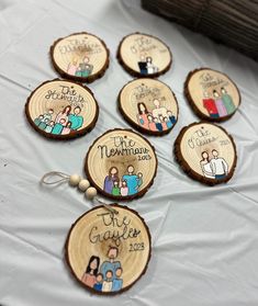 wooden ornaments with family pictures on them sitting on a table