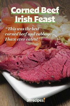 corned beef with cabbage and carrots on a white platter that says corned beef irish feast this was the best corned beef and cabbage i have ever eaten