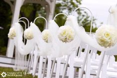 white chairs with flowers hanging from them