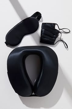 a pair of black shoes sitting on top of a white floor next to a mask