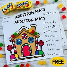 addition mats with candy and candies on the table next to them are free printables