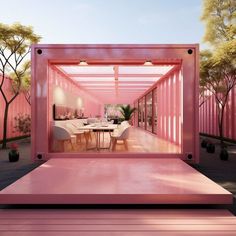 a pink box like structure with tables and chairs in it