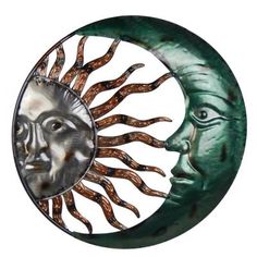 the sun and moon are depicted in this metal wall art piece, which features two faces