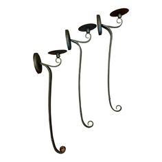 three wrought iron wall lights on white background