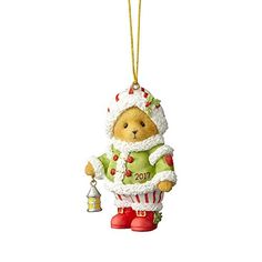 a christmas ornament with a teddy bear holding a bell