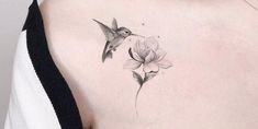 a woman's back with a hummingbird and flower tattoo on her left shoulder