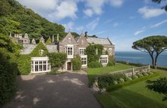 an aerial view of a large house near the ocean