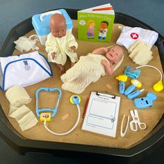 a baby is laying on a table with toys