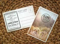 two postcards sitting on top of a woven basket next to an envelope with the same stamp