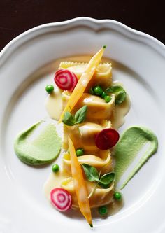 a white plate topped with pasta and veggies