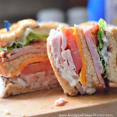 a cut in half sandwich sitting on top of a cutting board