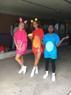 three girls dressed in costumes posing for the camera