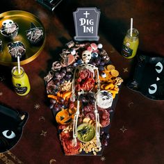 a table topped with lots of halloween food and decorations on top of eachother