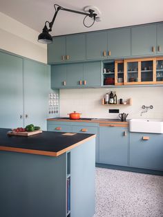 a kitchen with blue cabinets and an island