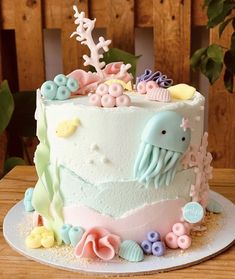 a cake decorated with sea animals and seashells