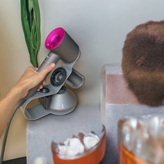 a person is using a hair dryer on top of a table with ice cubes