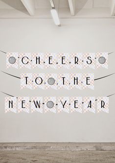 a white wall with some type of art on it that says cheers to the new - year