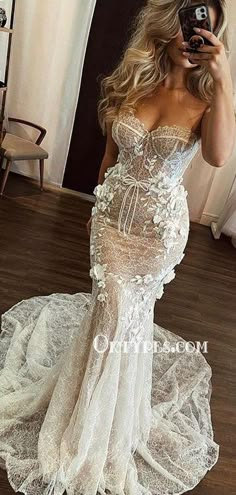 a woman taking a selfie in her wedding dress