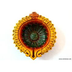 an orange and green broochle on a white background