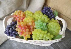 a basket filled with grapes sitting on top of a table