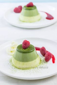 two desserts on plates with raspberries and green frosting, one topped with whipped cream