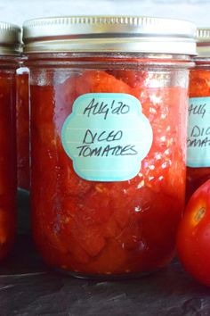 tomatoes are in jars with labels on them