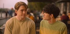 two young men sitting next to each other