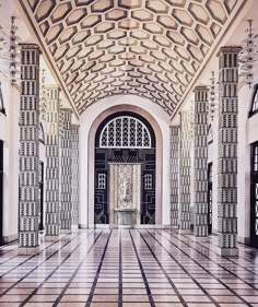 the inside of a building with columns and doors