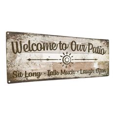 a wooden sign that says welcome to our patio with an arrow on the front and side