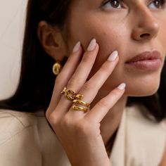 Upgrade your style with the Rue Ring! This stunning spiral ring adds a touch of elegance to any outfit. Its unique design is a perfect conversation starter and sure to catch anyone's eye. Elevate your look and feel confident with the Rue Ring. 18k Gold Plated over Stainless Steel Water & Tarnish Resistant Hypoallergenic Spiral Ring, Elevate Your Look, Conversation Starters, Steel Water, Feel Confident, Unique Design, 18k Gold, Gold Plate, Unique Designs