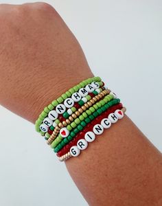 Grinch Stacking Seed Bead Bracelet,  Stink Stank Stunk, Grinch Gift, Christmas Jewelry, Holiday Bracelets, Gold, Green and Red Christmas How to find your bracelet size: Wrap a flexible tape measure, string, or ribbon around your wrist. Find your measurement and then add 1/2 an inch. This will ensure a comfortable fit for your stackable bracelets.   Bracelet care: -remove when sleeping -avoid over stretching -allow lotions to dry before wearing -remove before entering water -Made with clear stretchy elastic cord. Looking for different text on your bracelet?  Feel free to contact me with any personalization. Christmas Stretch Bracelets Ideas, Grinch Friendship Bracelet, Grinch Beaded Bracelet, Grinch Bracelet Ideas, Christmas Seed Bead Bracelets, Christmas Bead Bracelets, Christmas Friendship Bracelets, Grinch Jewelry, Christmas Bracelets Beaded