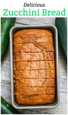 a loaf of zucchini bread sitting in a pan on top of a wooden table