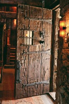 an old wooden door with wrought iron bars on the front and side, in a rustic style